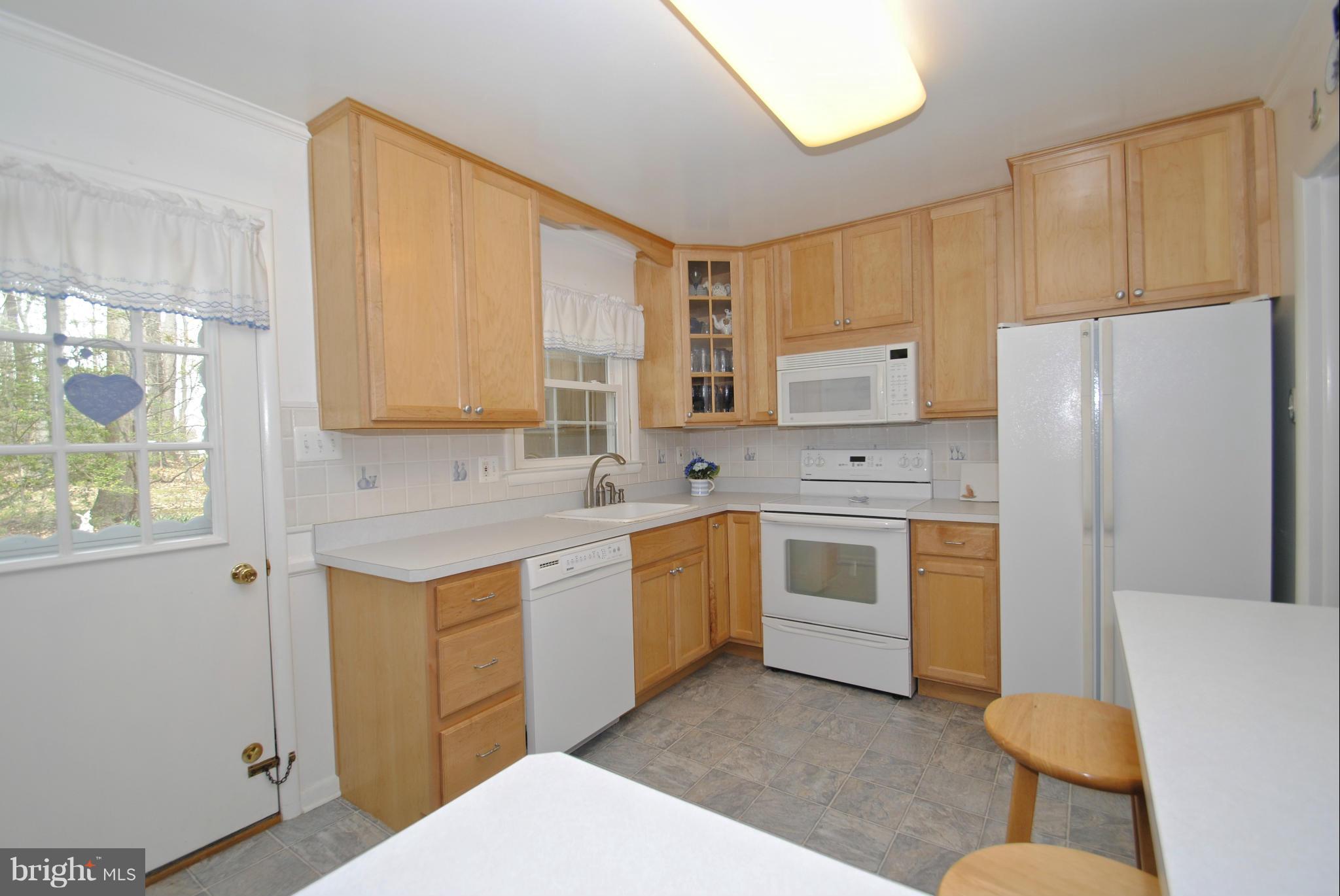 985 Chesterfield Road Annapolis, MD 21401 - Photo 12 of 30 a kitchen with stainless steel appliances a refrigerator sink and cabinets