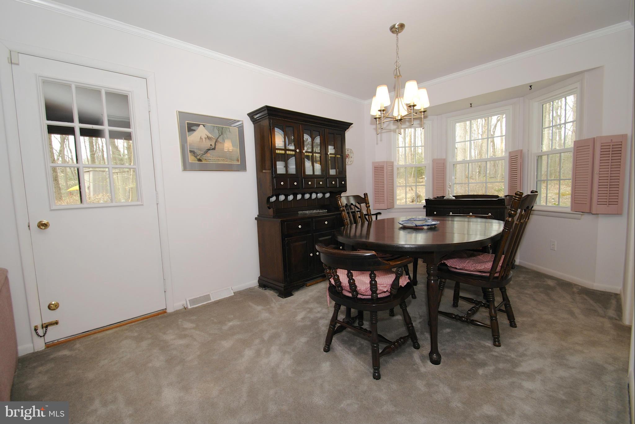 985 Chesterfield Road Annapolis, MD 21401 - Photo 14 of 30 a dining room with furniture a chandelier and window