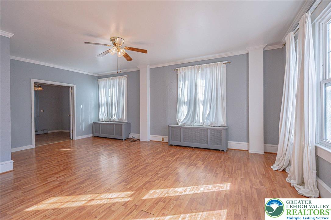 451 East Broad Street Tamaqua, PA 18252 - Photo 12 of 66 a view of an empty room with a window and wooden floor