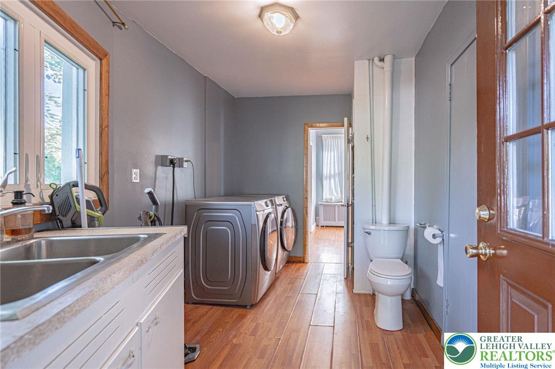 451 East Broad Street Tamaqua, PA 18252 - Photo 18 of 66 a view of a kitchen with a sink and wooden floor