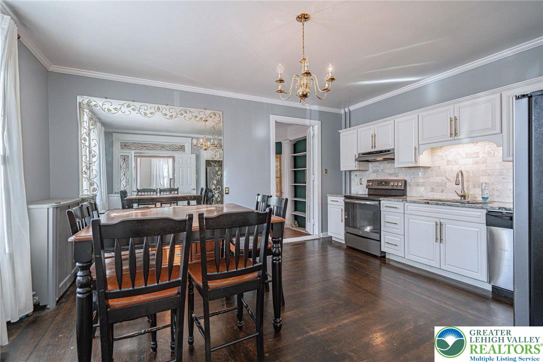 451 East Broad Street Tamaqua, PA 18252 - Photo 19 of 66 a open dining room with stainless steel appliances kitchen island granite countertop furniture and wooden floor