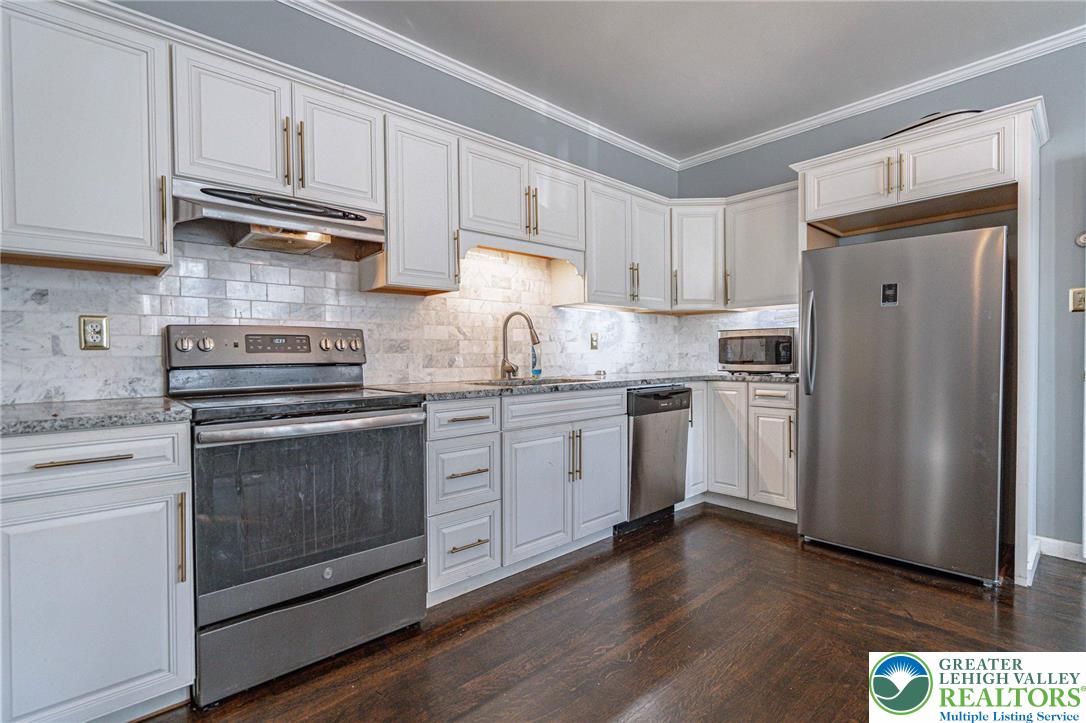 451 East Broad Street Tamaqua, PA 18252 - Photo 22 of 66 a kitchen with granite countertop white cabinets and stainless steel appliances