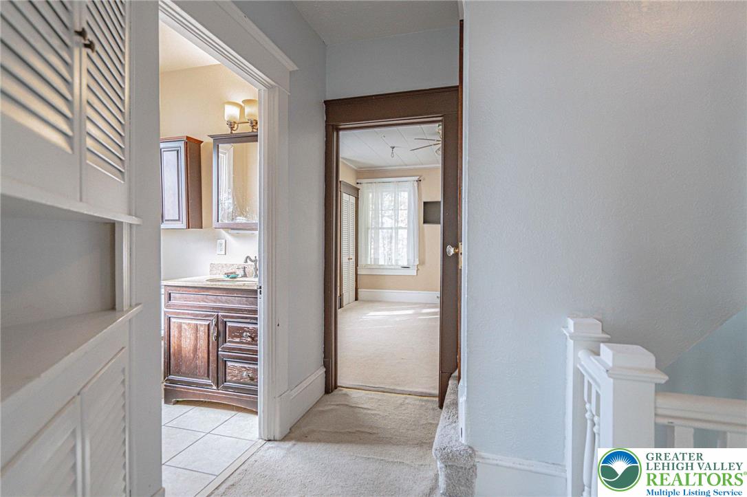 451 East Broad Street Tamaqua, PA 18252 - Photo 27 of 66 a bathroom with a double vanity sink and a mirror