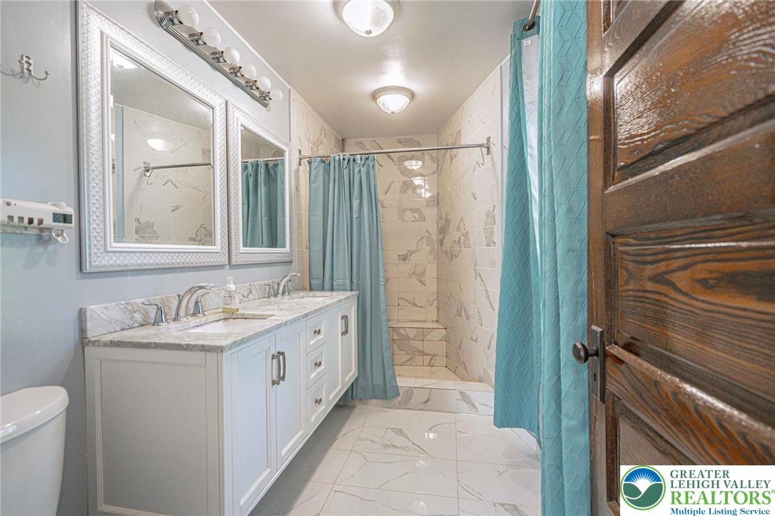 451 East Broad Street Tamaqua, PA 18252 - Photo 32 of 66 a bathroom with a double vanity sink toilet and shower