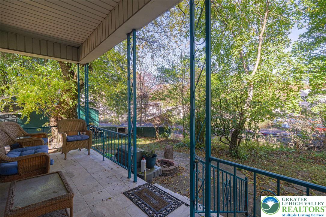 451 East Broad Street Tamaqua, PA 18252 - Photo 56 of 66 a view of a patio with a table chairs and a floor to ceiling window