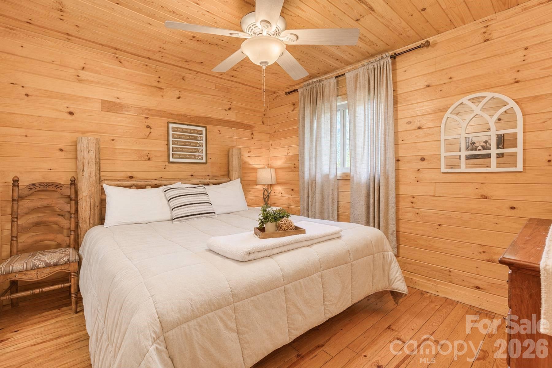 319 Blue Ridge Parkway, Unit 53 Bryson City, NC 28713 - Photo 10 of 22 a bedroom with a bed and a mirror