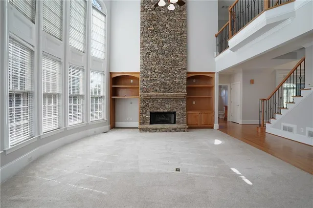 a kitchen with stainless steel appliances granite countertop a refrigerator oven a sink dishwasher and wooden cabinets with wooden floor