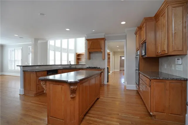 wooden floor fireplace and windows in an empty room