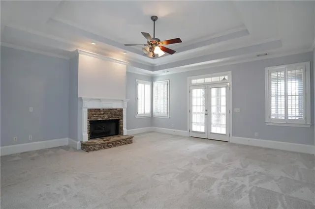 a view of an empty room and a ceiling fan