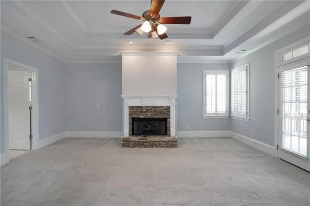 a view of an empty room with a ceiling fan and a window