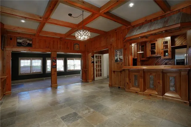 an aerial view of a house with a swimming pool and outdoor seating