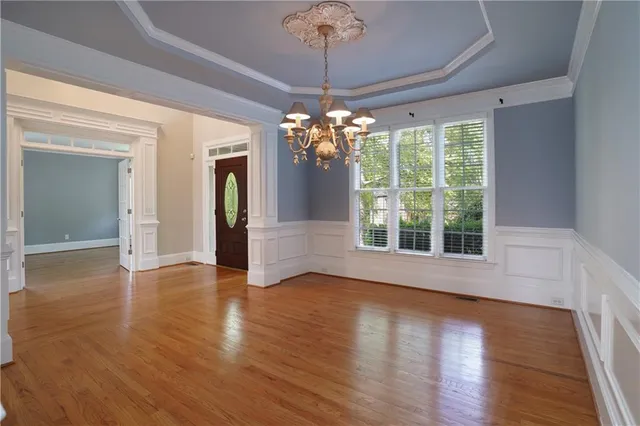 a view of an empty room with a fireplace and a window