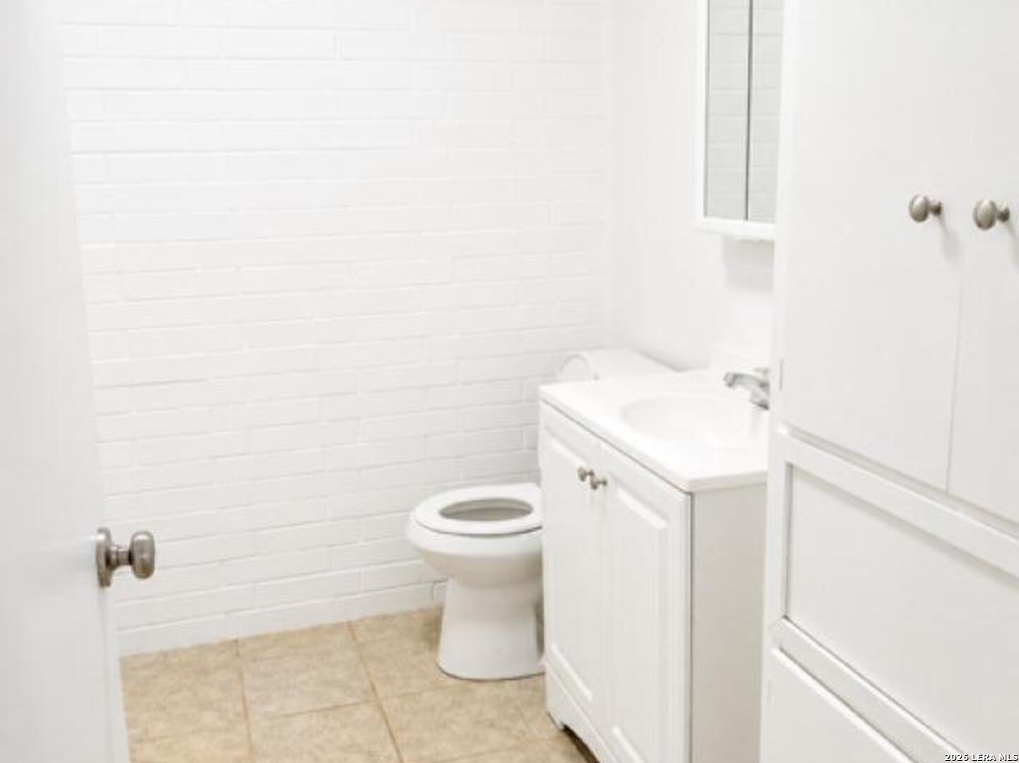 208 Forrest Road, Unit A La Vernia, TX 78121 - Photo 5 of 7 a white toilet sitting next to a white sink