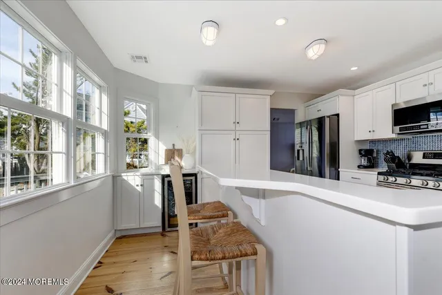 a kitchen with granite countertop a refrigerator stove and sink