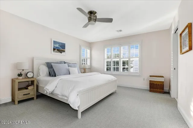 a spacious bedroom with a bed a couch and a window