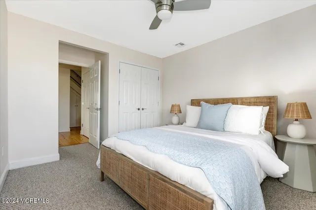 a bedroom with bed and a chandelier