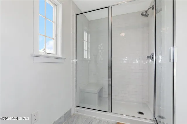 a bathroom with a glass shower door
