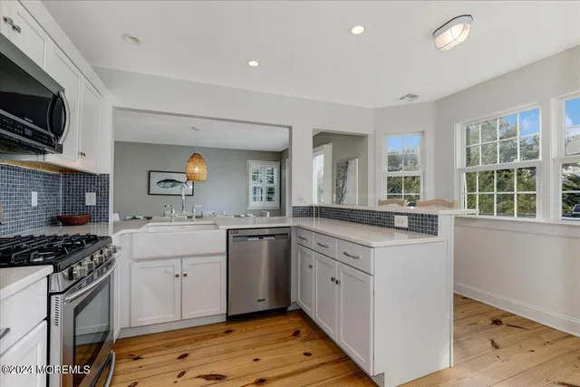 a kitchen that has a sink and a stove in it