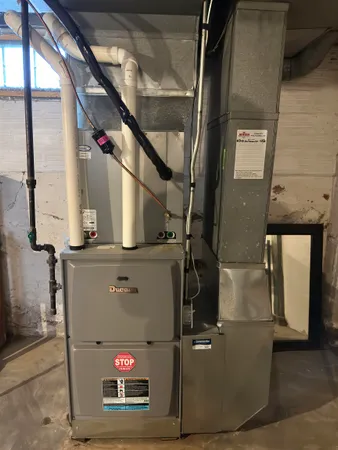a front view of a house with a yard covered in snow