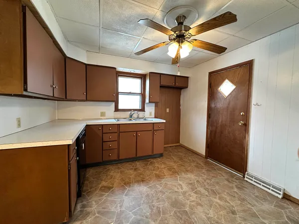 a kitchen with a refrigerator sink and cabinets