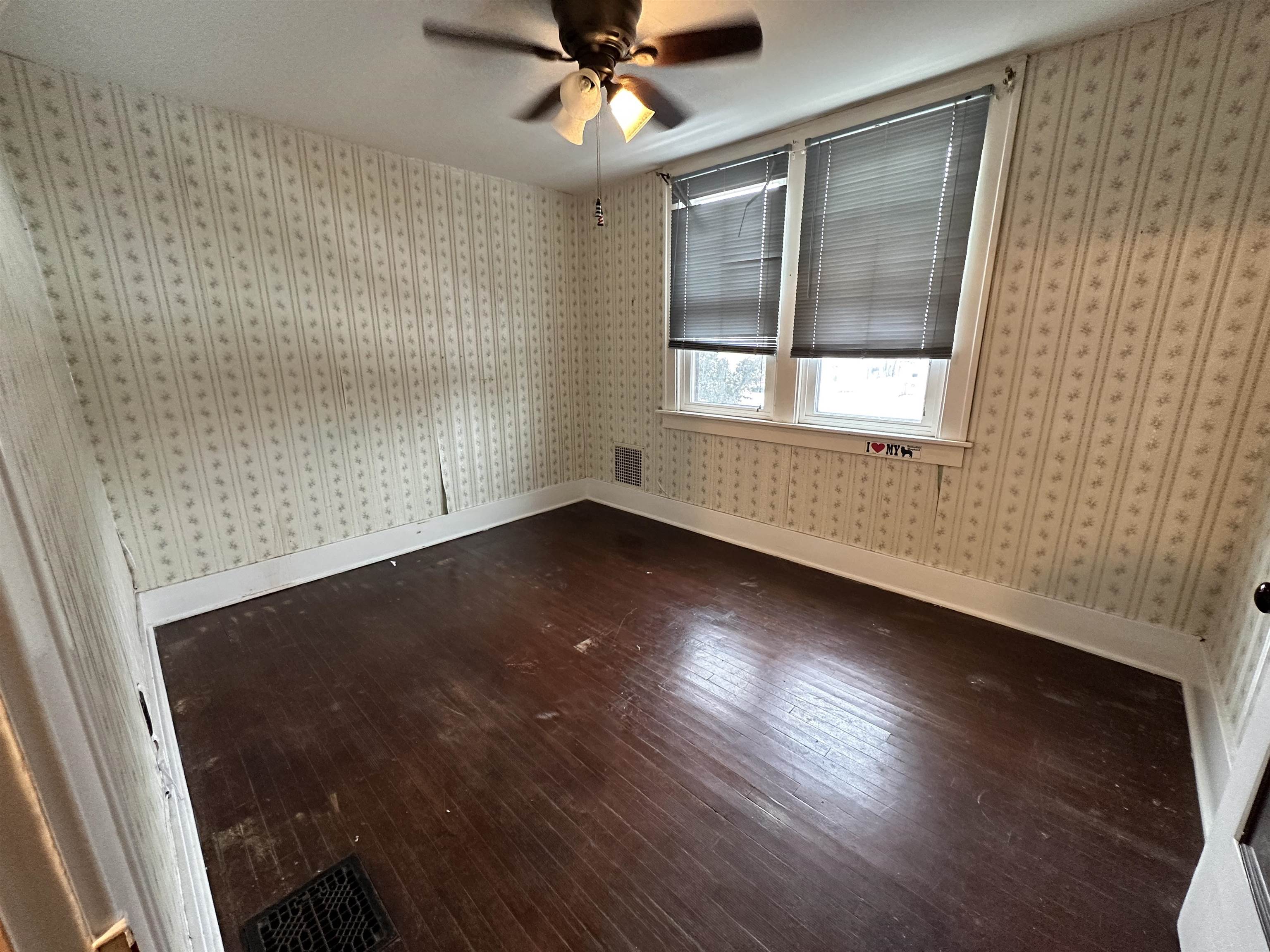 1441 South Float Avenue Freeport, IL 61032 - Photo 5 of 31 an empty room with wooden floor fan and windows