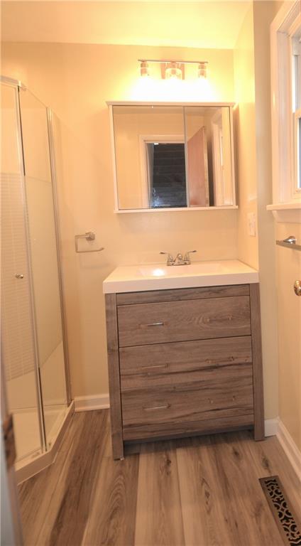 340 Prestley Road Bridgeville, PA 15017 - Photo 22 of 23 a bathroom with a sink a mirror and a vanity