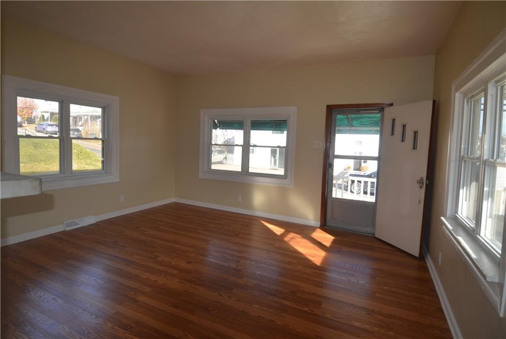 340 Prestley Road Bridgeville, PA 15017 - Photo 6 of 23 a view of an empty room with wooden floor and a window