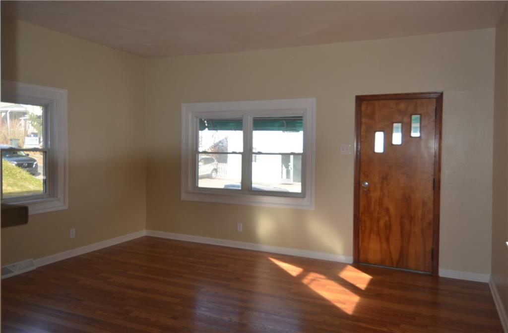340 Prestley Road Bridgeville, PA 15017 - Photo 7 of 23 a view of an empty room with wooden floor and a window
