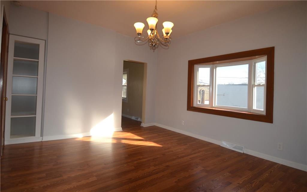 340 Prestley Road Bridgeville, PA 15017 - Photo 8 of 23 a view of an empty room with wooden floor and a window