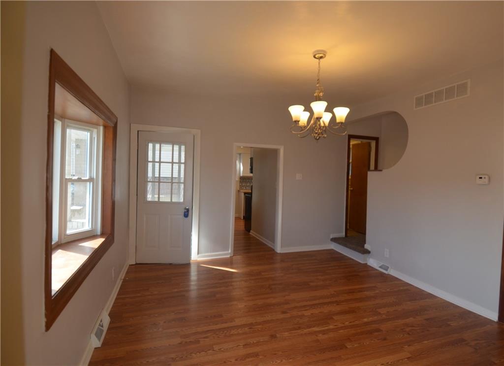 340 Prestley Road Bridgeville, PA 15017 - Photo 9 of 23 a view of a livingroom with a chandelier wooden floor and a chandelier