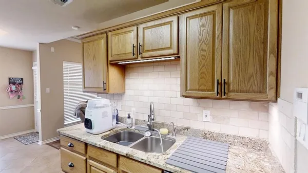a kitchen with a sink cabinets and window