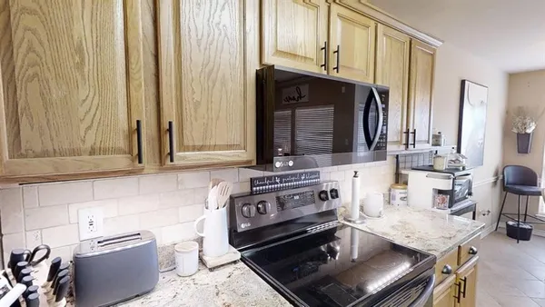 a kitchen with stainless steel appliances granite countertop a sink and a stove