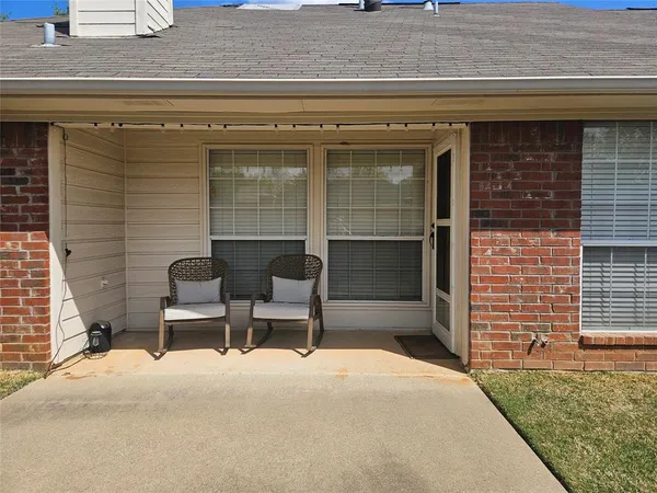 a couple of chairs in front of door