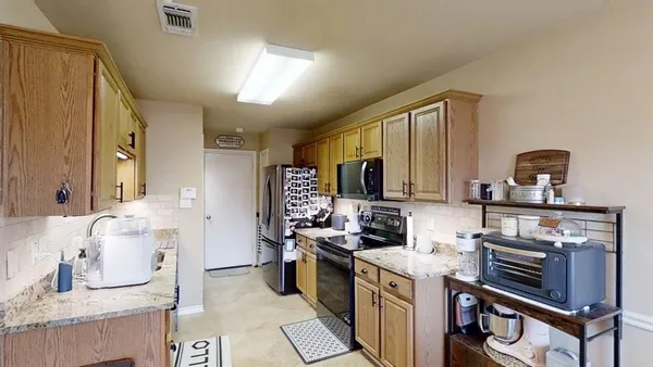 a kitchen with a stove a sink and a refrigerator