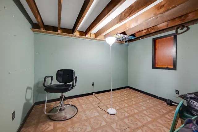 a kitchen with granite countertop a refrigerator and white cabinets
