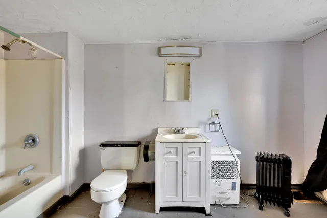 a picture of a room with a white wall and a picture