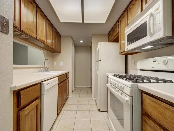 a kitchen with stainless steel appliances granite countertop a stove and a sink