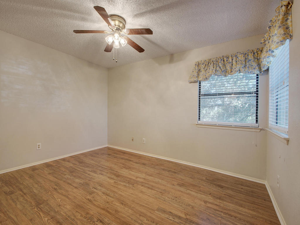 11301 Jollyville Road, Unit A3 Austin, TX 78759 - Photo 17 of 26 a view of an empty room with a window and a ceiling fan