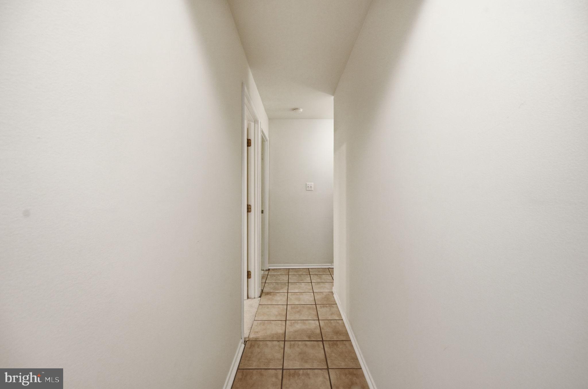 2908 Jermantown Road, Unit 24 Oakton, VA 22124 - Photo 61 of 74 Inviting corridor with tiled floor.