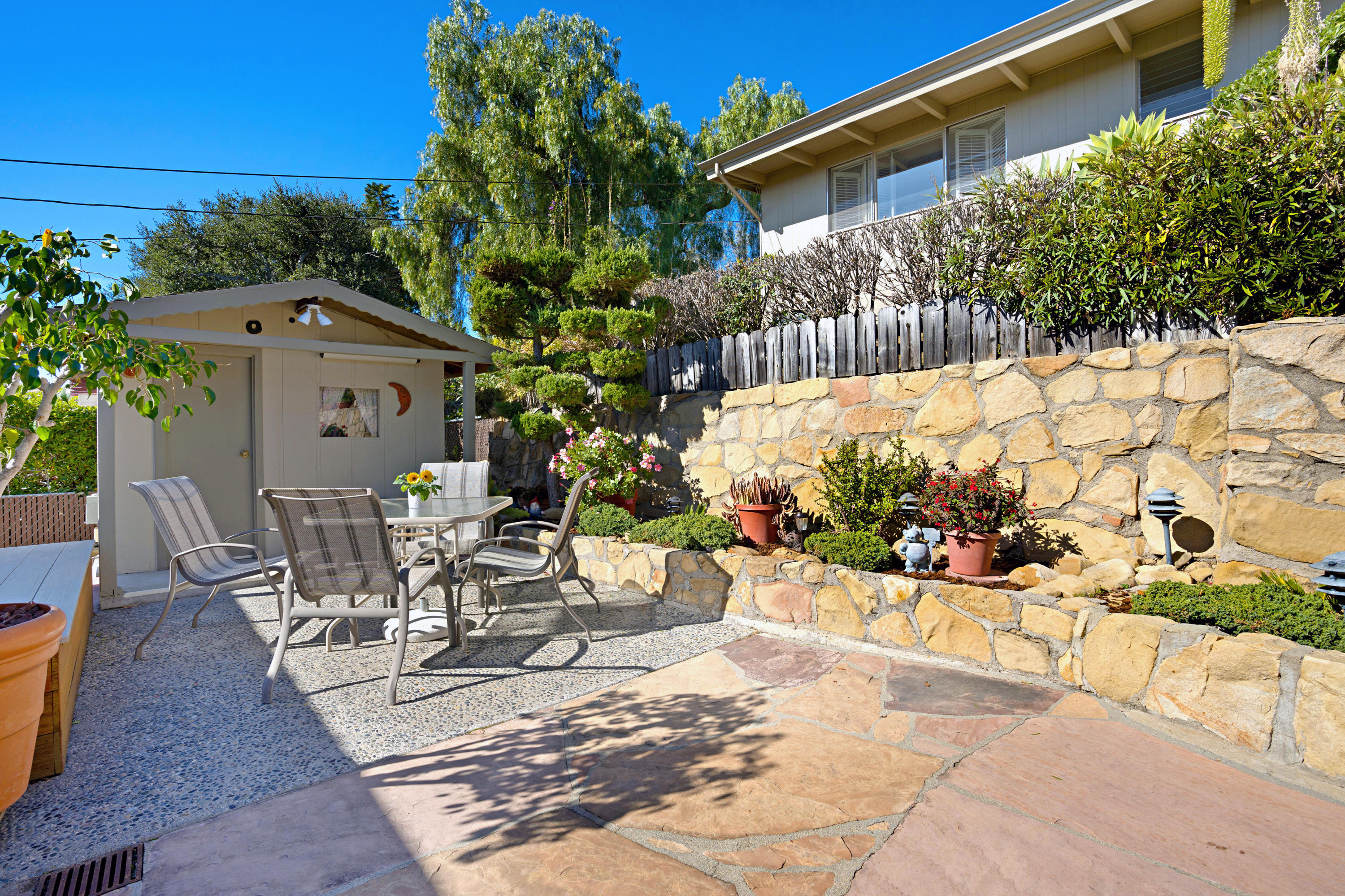 817 Arguello Road Santa Barbara, CA 93103 - Photo 36 of 42 a view of a patio with a table and chairs