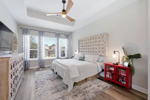 a bedroom with a large bed and a tv