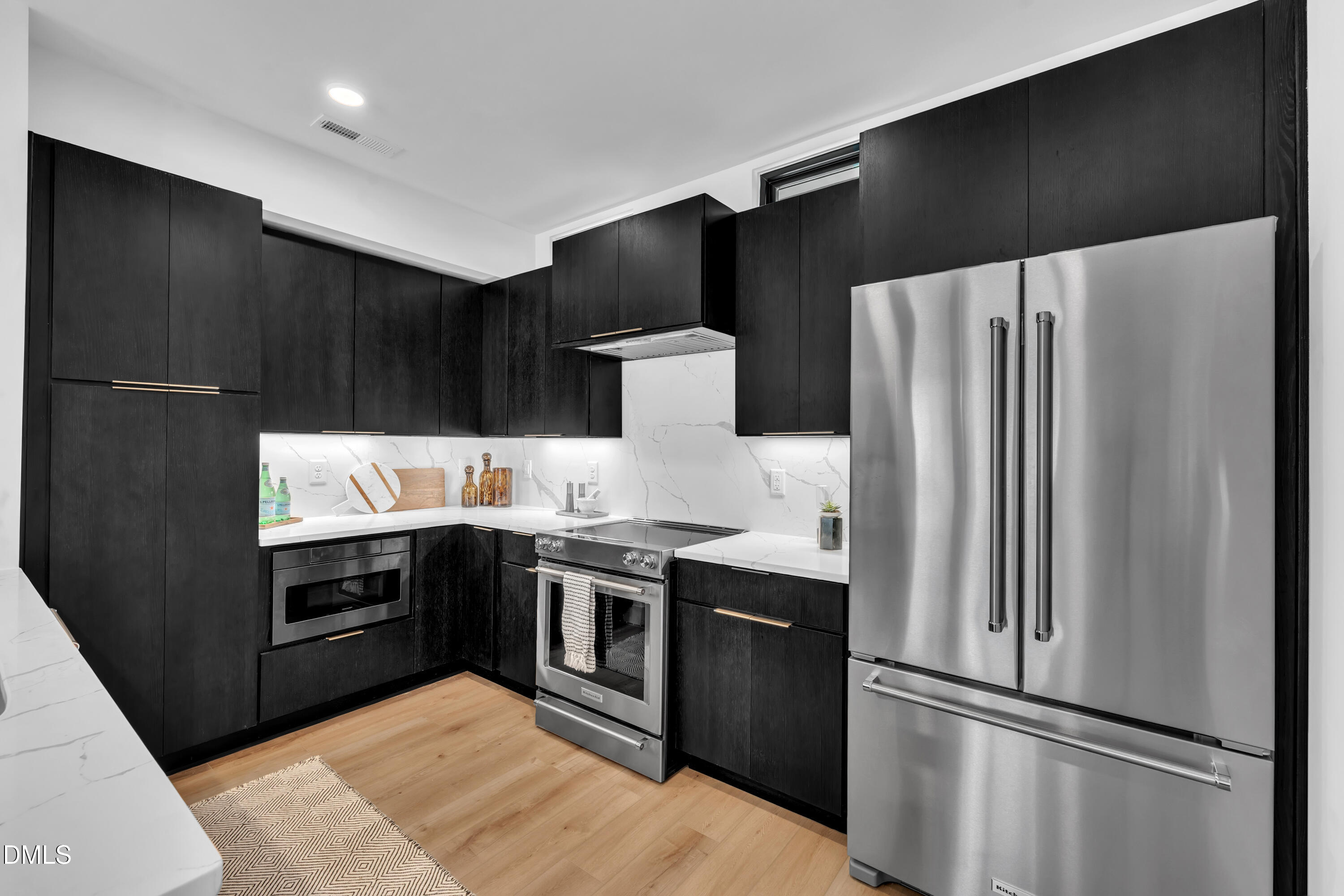 512 Gordon Street, Unit 1101 Durham, NC 27701 - Photo 11 of 32 a kitchen with stainless steel appliances granite countertop a refrigerator and a stove