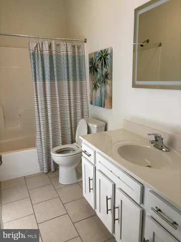 a bathroom with a double vanity sink toilet and shower