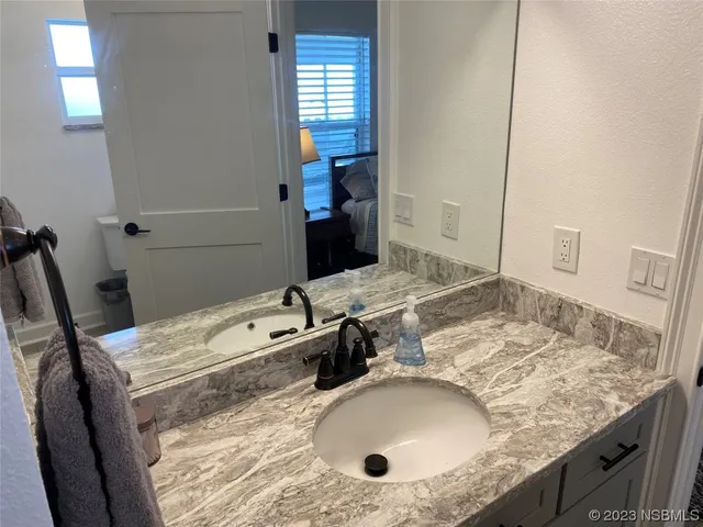 a kitchen with stainless steel appliances granite countertop a stove top oven a sink dishwasher a dining table and chairs with wooden floor