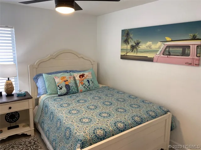 a bedroom with furniture and a flat screen tv