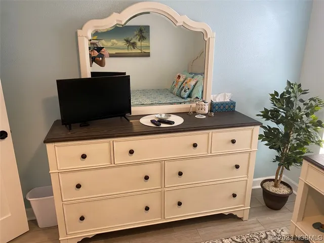 a bedroom with a bed and a lamp