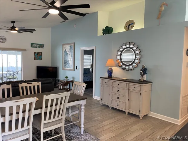 a living room with furniture a flat screen tv and a wooden floor
