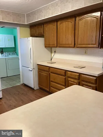 a kitchen with a refrigerator and a sink