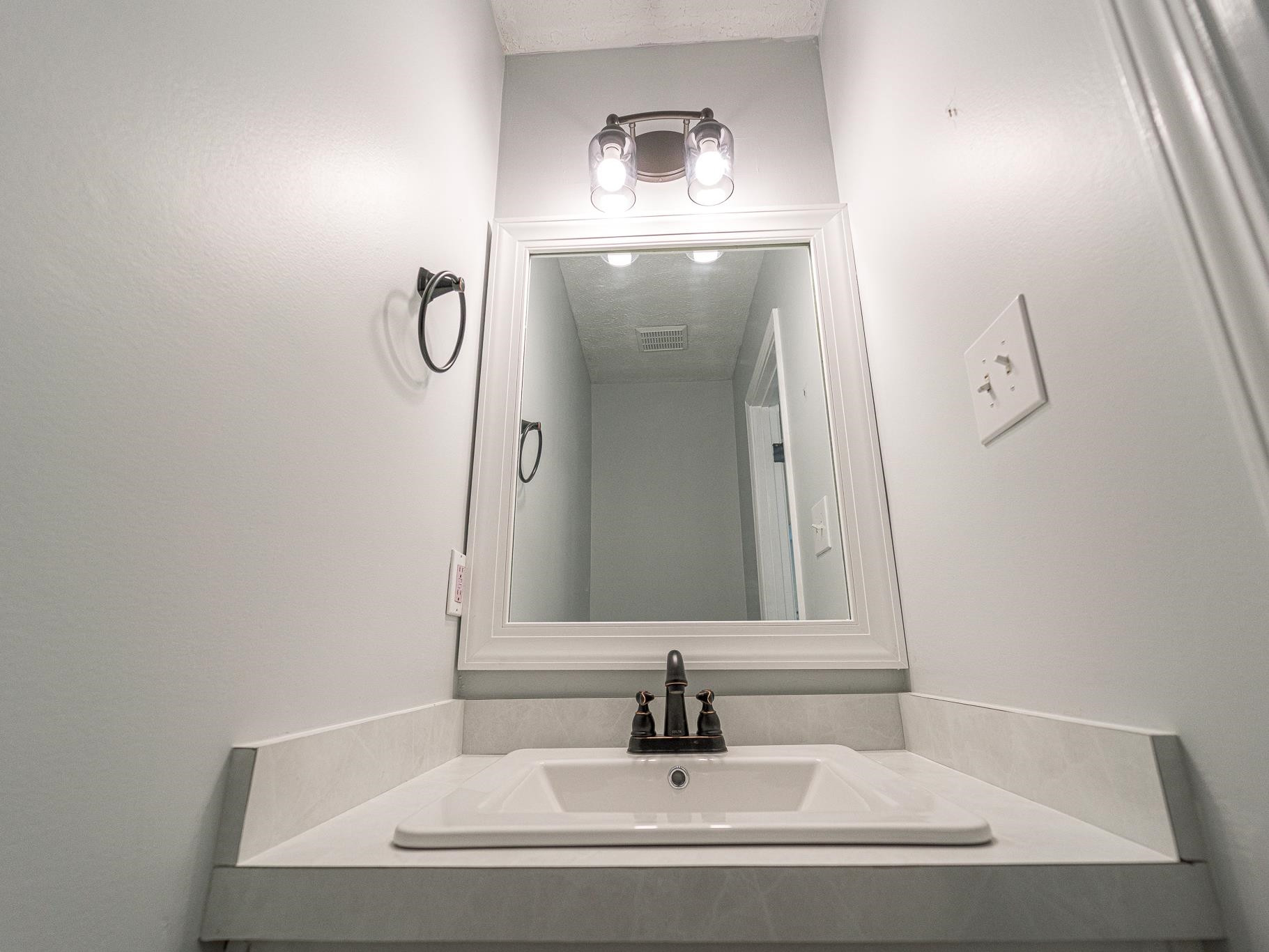 9961 Old Middlesex Road Middlesex, NC 27557 - Photo 13 of 30 a bathroom with a sink and a mirror