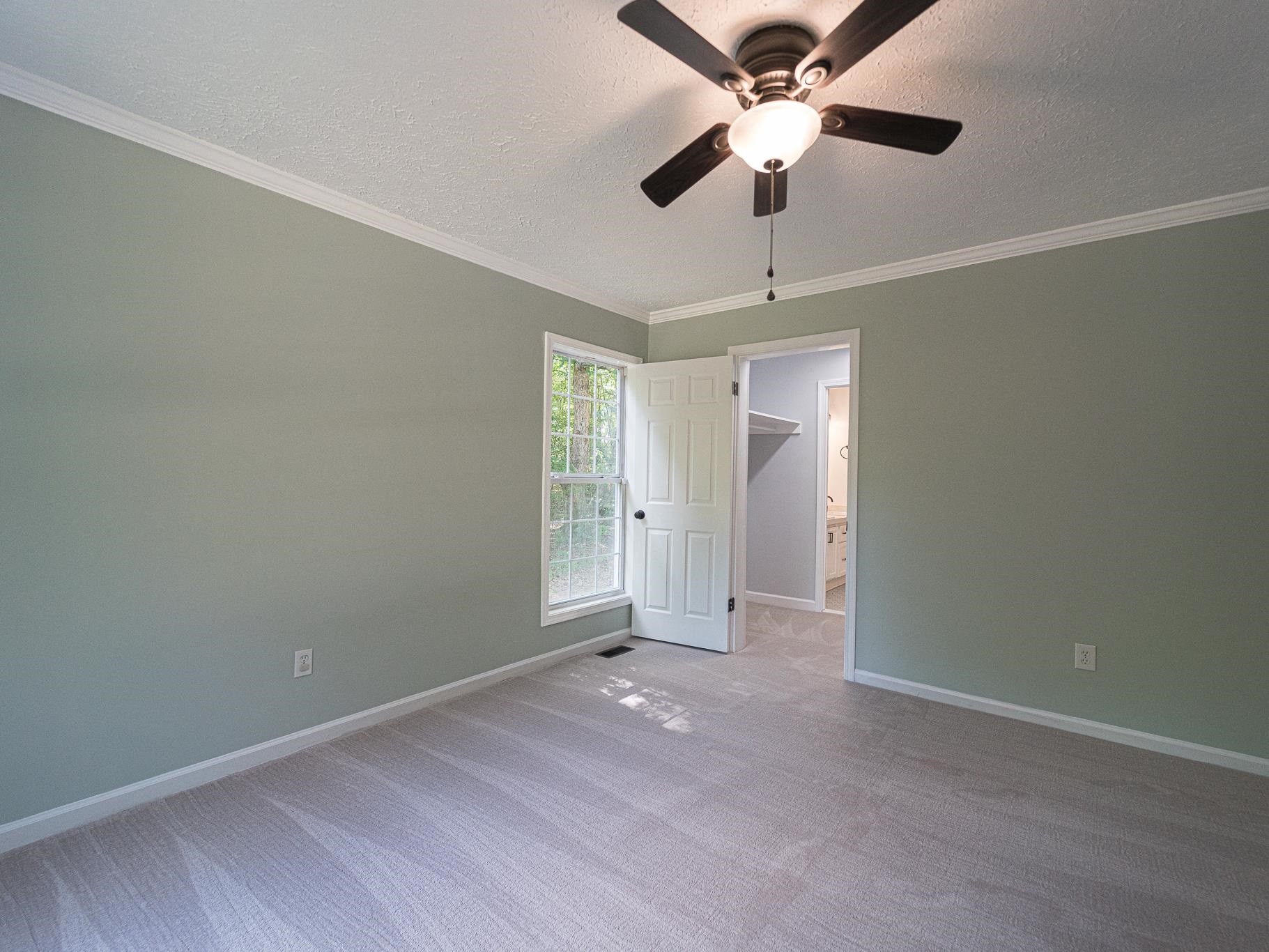 9961 Old Middlesex Road Middlesex, NC 27557 - Photo 15 of 30 an empty room with closet and a chandelier fan